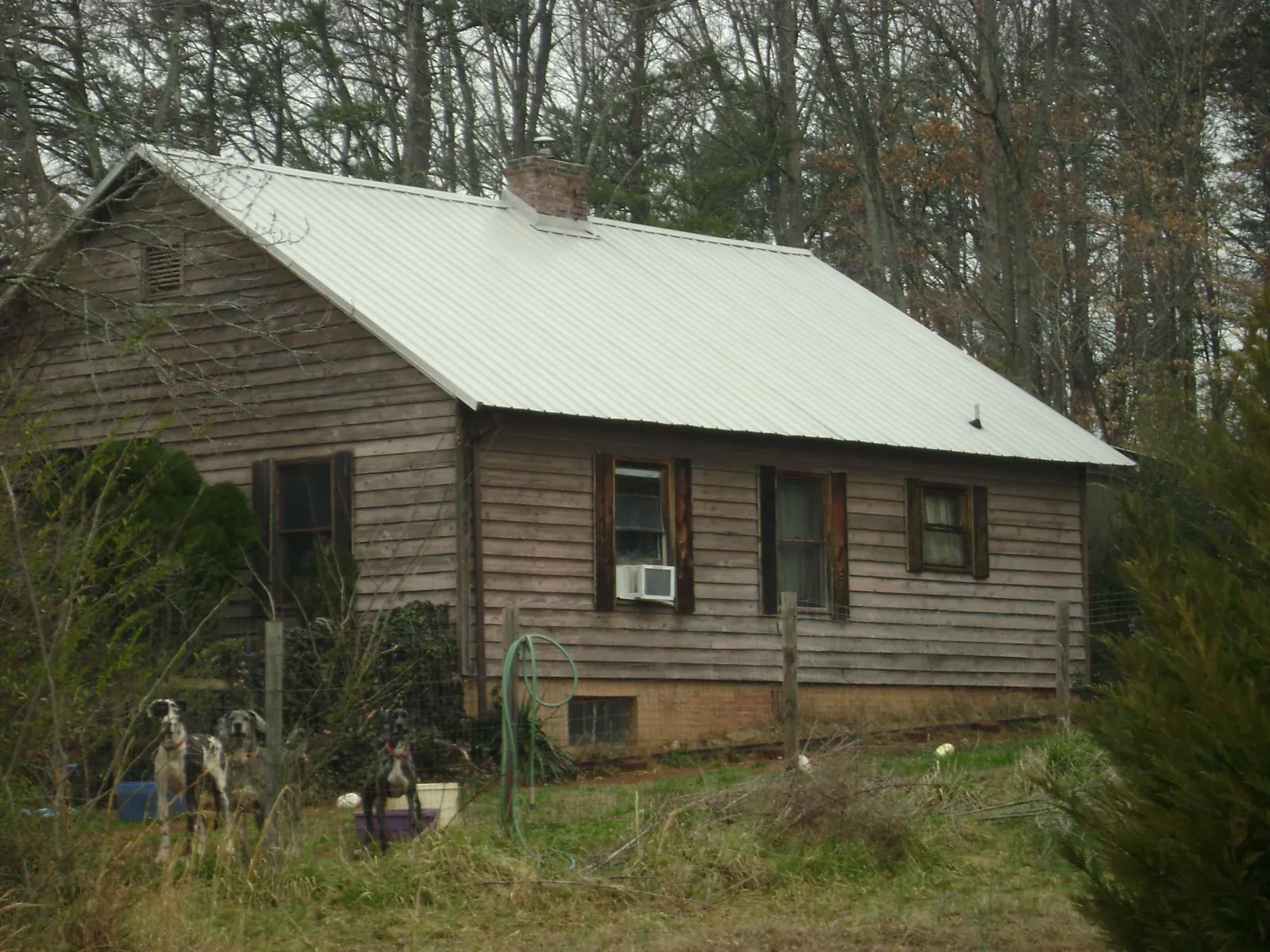 White metal roof on an old wood sided farmhouse, from a Asphalt Shingle Roof Repair job in East Nassau